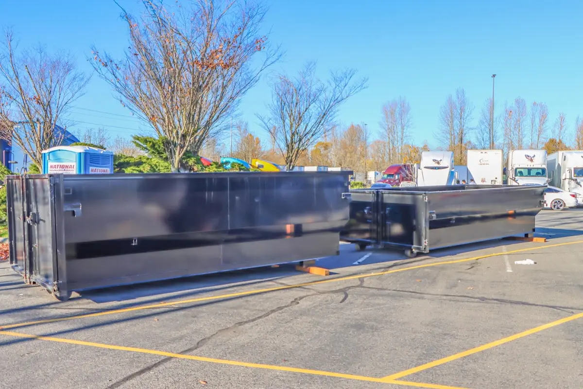 Professional dumpster rental service with roll-off container on residential driveway in Draper